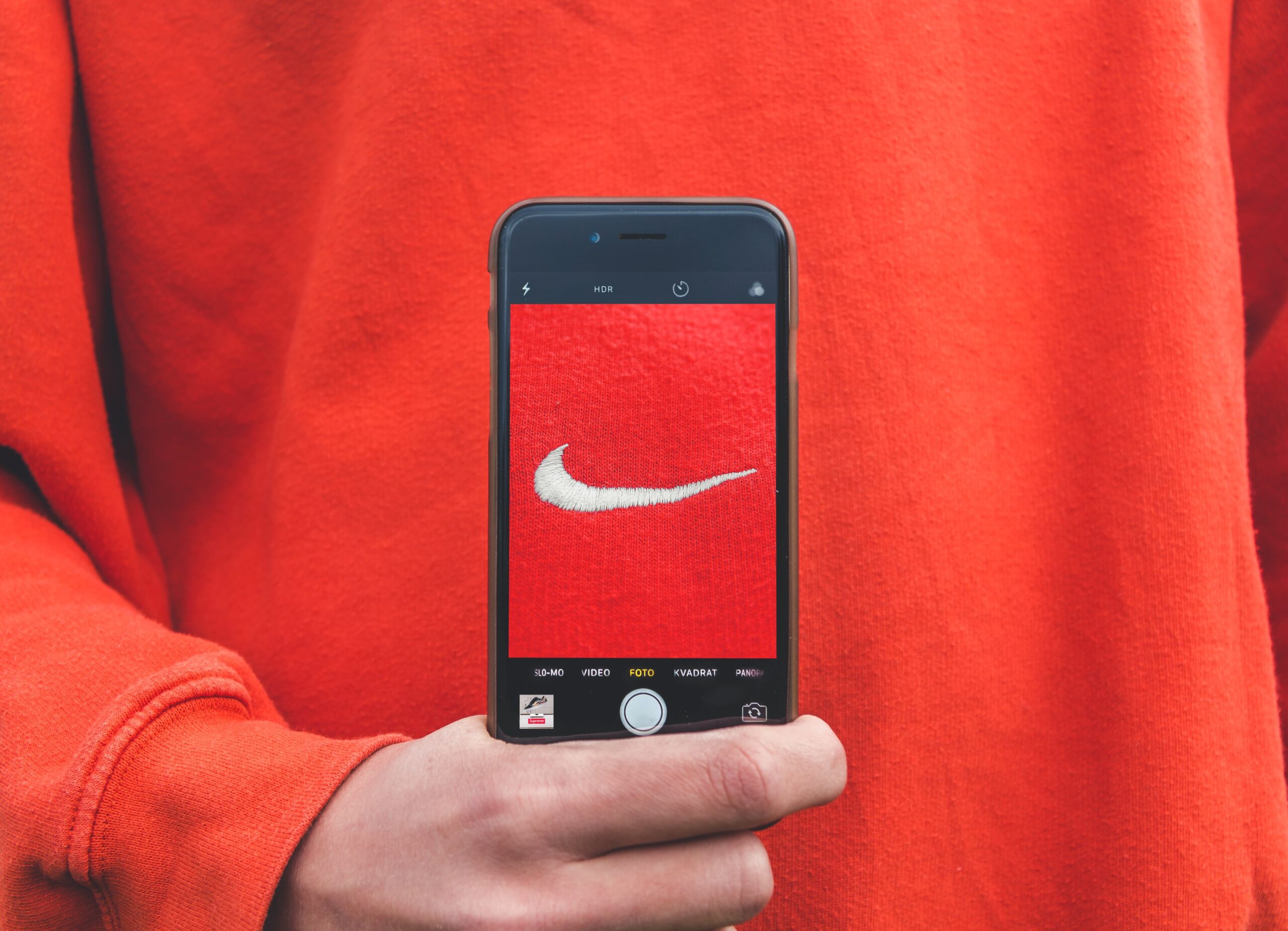 Selfie using iphone wearing nike red sweatshirt for article on effective branding for businesses